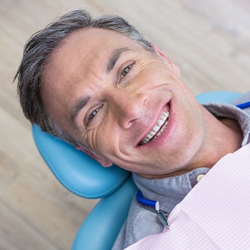 man smiling laying back in exam chair