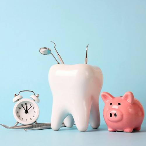 a tooth with dental tools next to a piggy bank