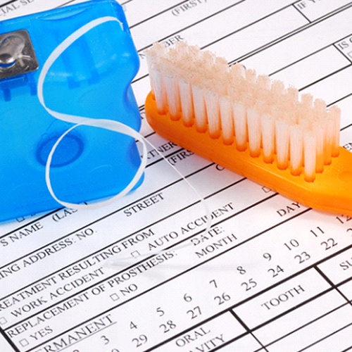 Dental insurance form, floss, and toothbrush