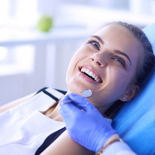 Happy woman in dental chair