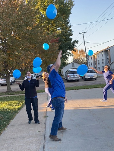 team playing with blue balloons