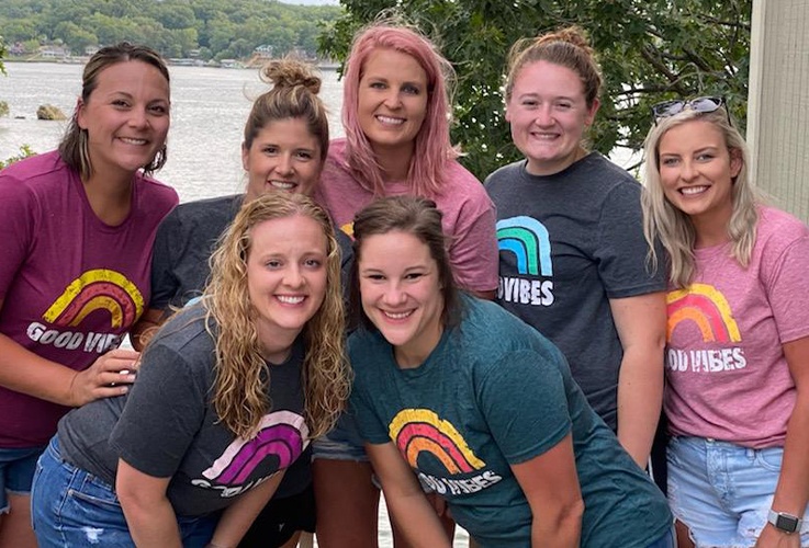 Kobza Dental team smiling by lake