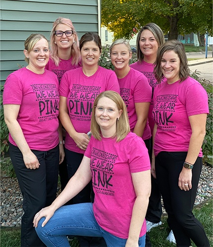 Team with matching pink shirts