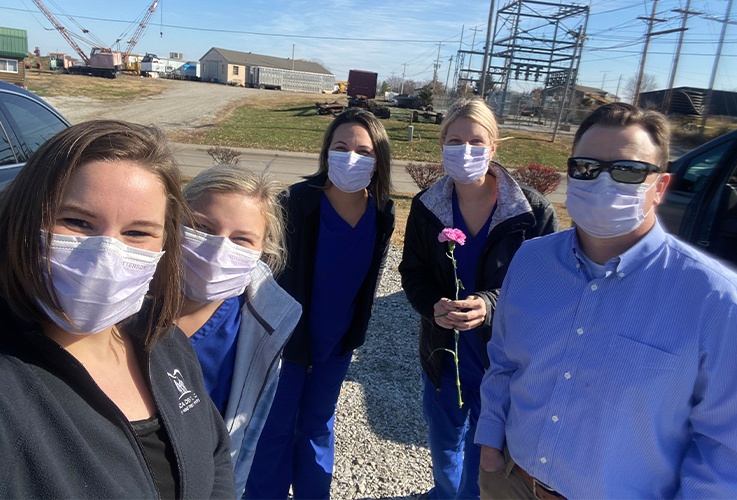 team with masks on smiling