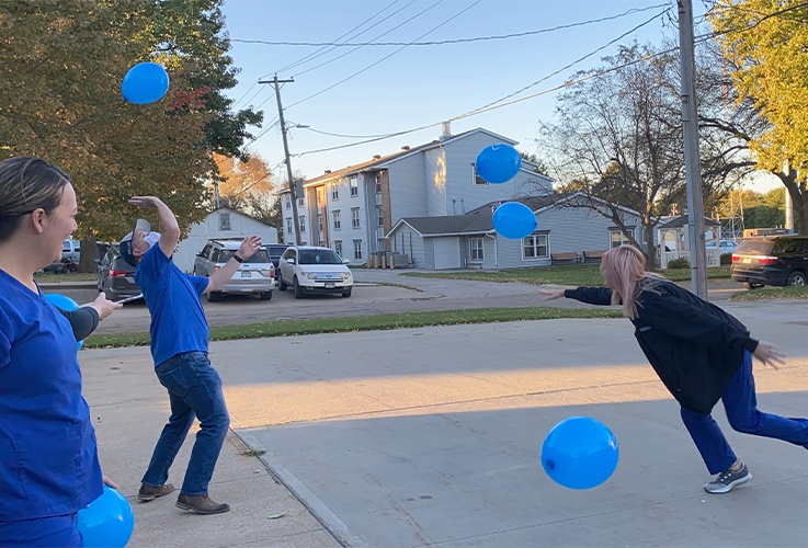 team hitting blue balloons