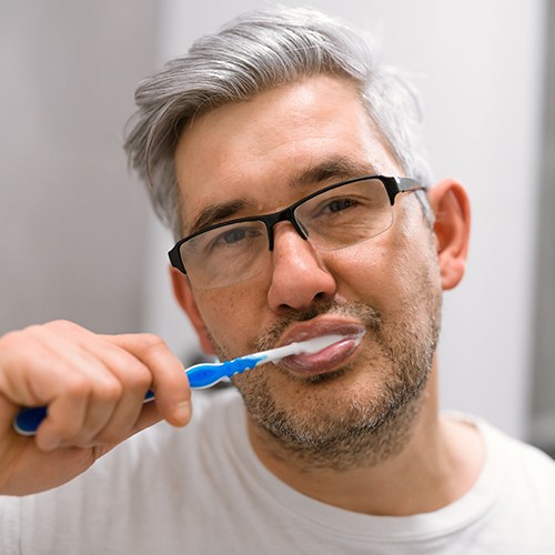 man brushing teeth