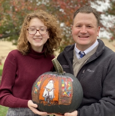 Dr. Kobza and daughter holding pumpkin