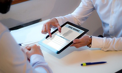 Patient reviewing dental insurance form on tablet