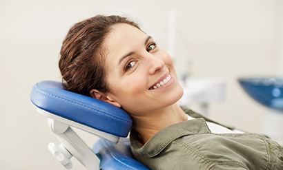 Woman smiling while sitting in treatment chair
