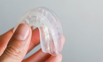 Patient holding clear mouthguard