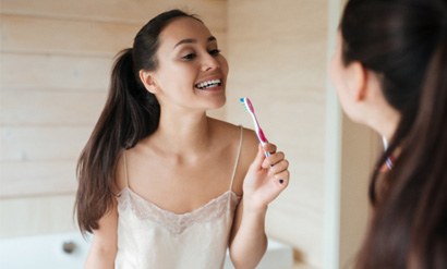 Woman holding a toothbrush