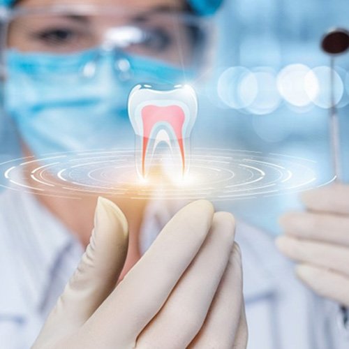 a closeup of a dentist utilizing technology