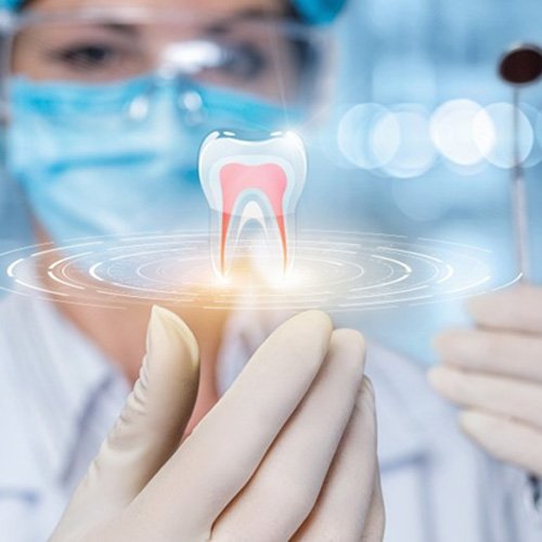 a closeup of a dentist utilizing technology
