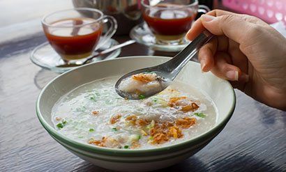 a closeup of someone eating a bowl of soup