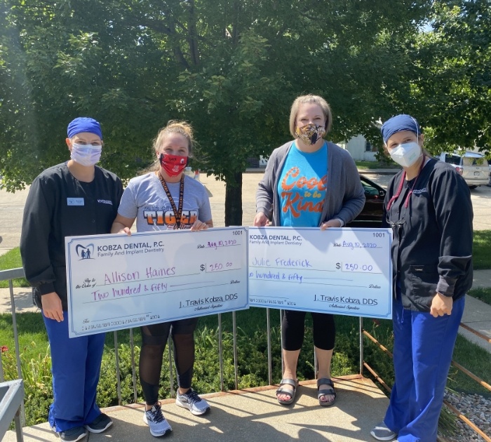 Falls City team with donated checks