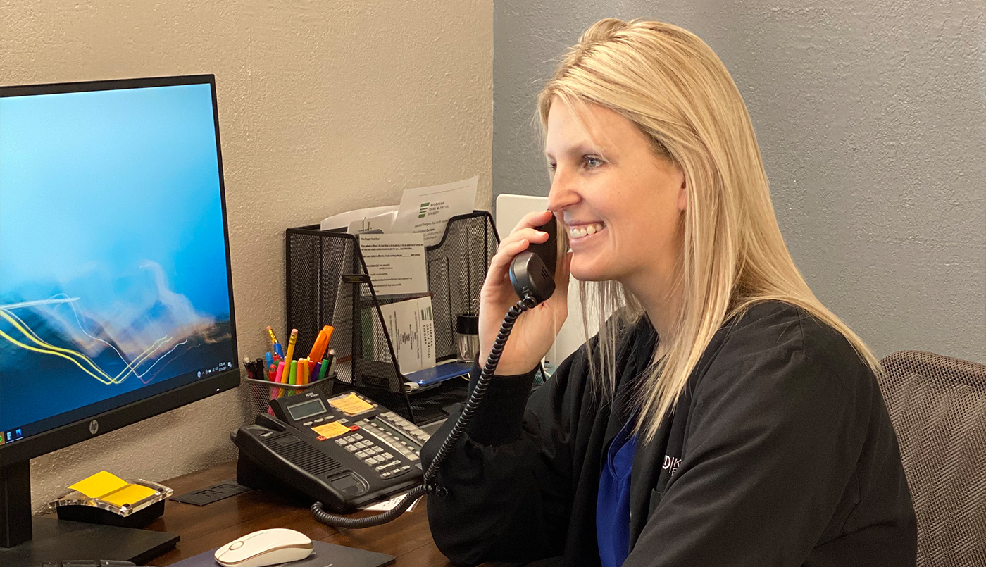 Kobza Dental team member on the phone