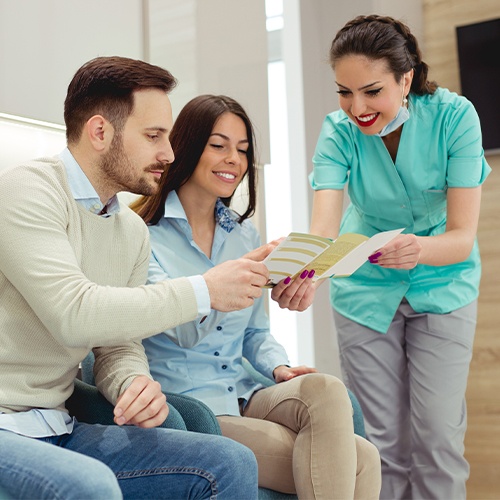 team member showing couple paperwork