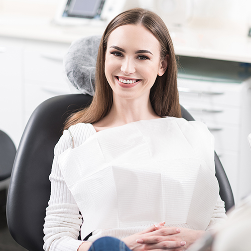 girl in chair smiling at camera