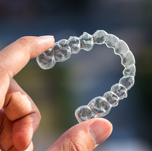 hand holding clear aligner