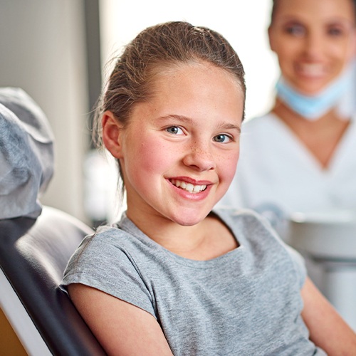 young girl sitting in exam chair