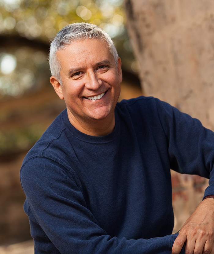 man in black sweater smiling