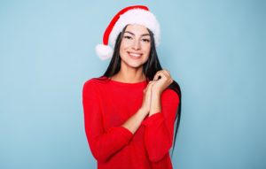 woman in Santa hat smiling