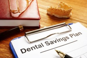 dental discount plan form on a blue clipboard