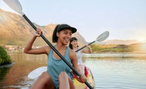 smiling ladies in a canoe during summer